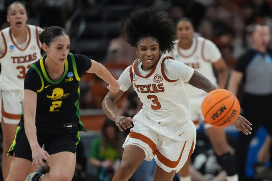Texas guard Rori Harmon (3) and Oregon guard Katie Fiso (2) chase a loose ball during the second half in the second round of the NCAA college basketball tournament, Sunday, March 22, 2026, in Austin, Texas. (AP Photo/Eric Gay)