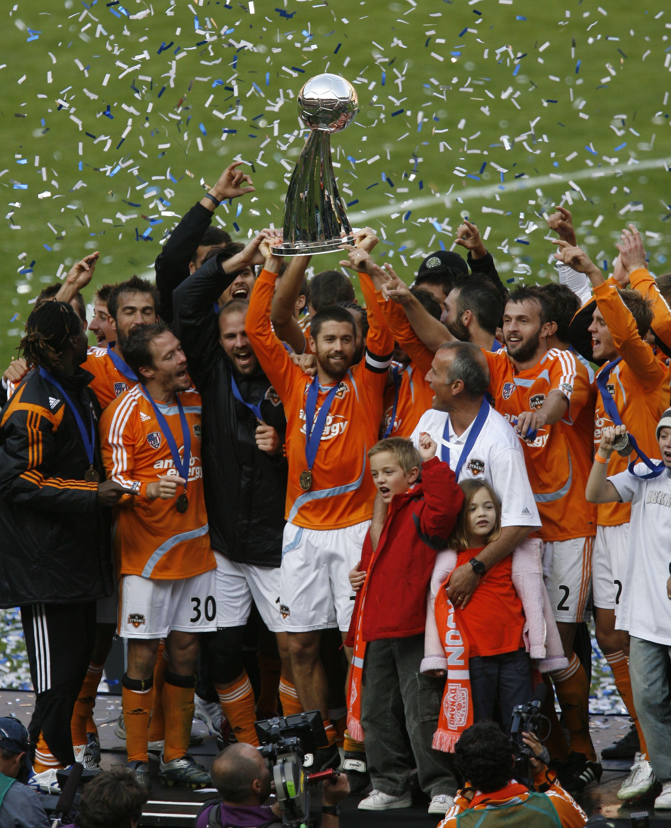 The Houston Dynamo’s Wade Barrett hoist the Alan I. Rothenberg trophy in the air along with teammates and family after the Dynamo defeated the New England Revolution in the 2007 MLS Cup at RFK Stadium Sunday, Nov. 18, 2007, in Washington. ( James Nielsen / Chronicle ) (Photo by James Nielsen/Houston Chronicle via Getty Images)
