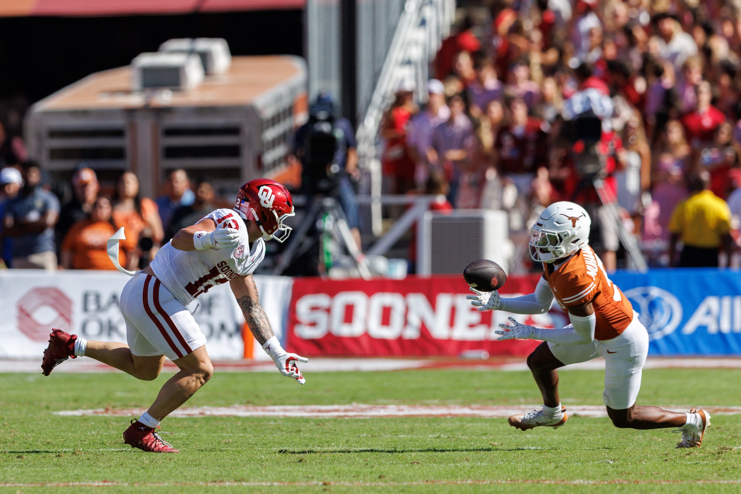 DALLAS, TX - OCTOBER 11: defensive back Malik Muhammad (5) of the Texas Longhorns makes an interception around wide receiver Zion Ragins (13) of the Oklahoma Sooners on October, 11th, 2025 in Dallas Texas. (Photo by William Purnell/Icon Sportswire via Getty Images)