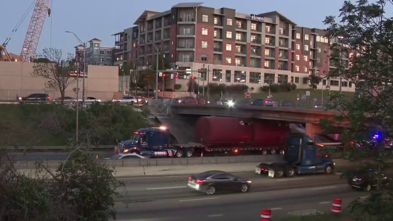 Truck gets wedged under I-35 overpass