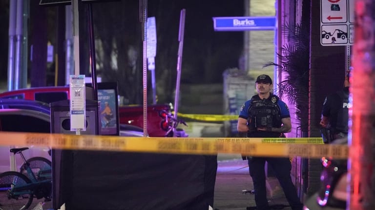 An Austin police officer guards the scene on West 6th...