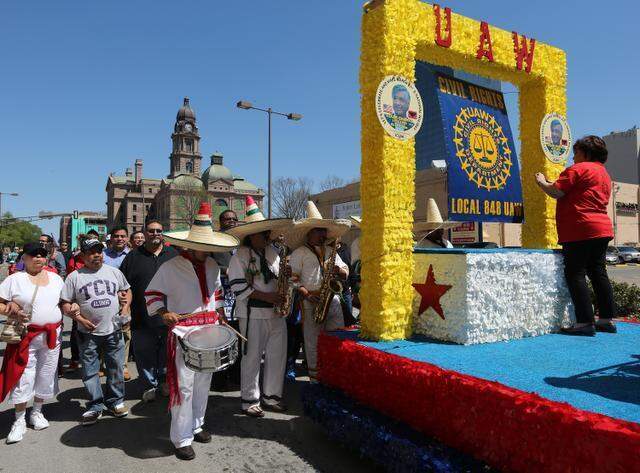 About 1,000 participants march through downtown Fort Worth to honor the birthday of American labor and civil rights activist Cesar Chavez on March 29, 2014.