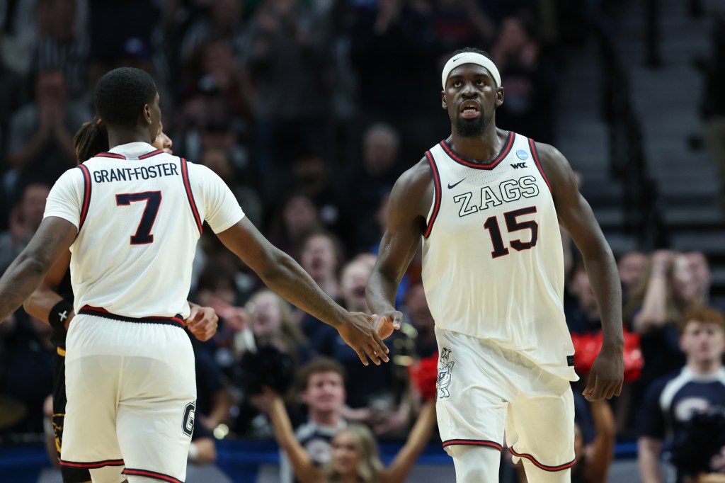 Gonzaga forward Graham Ike (15) reacts with guard Tyon Grant-Foster after a play during the second half of an NCAA college basketball tournament game.