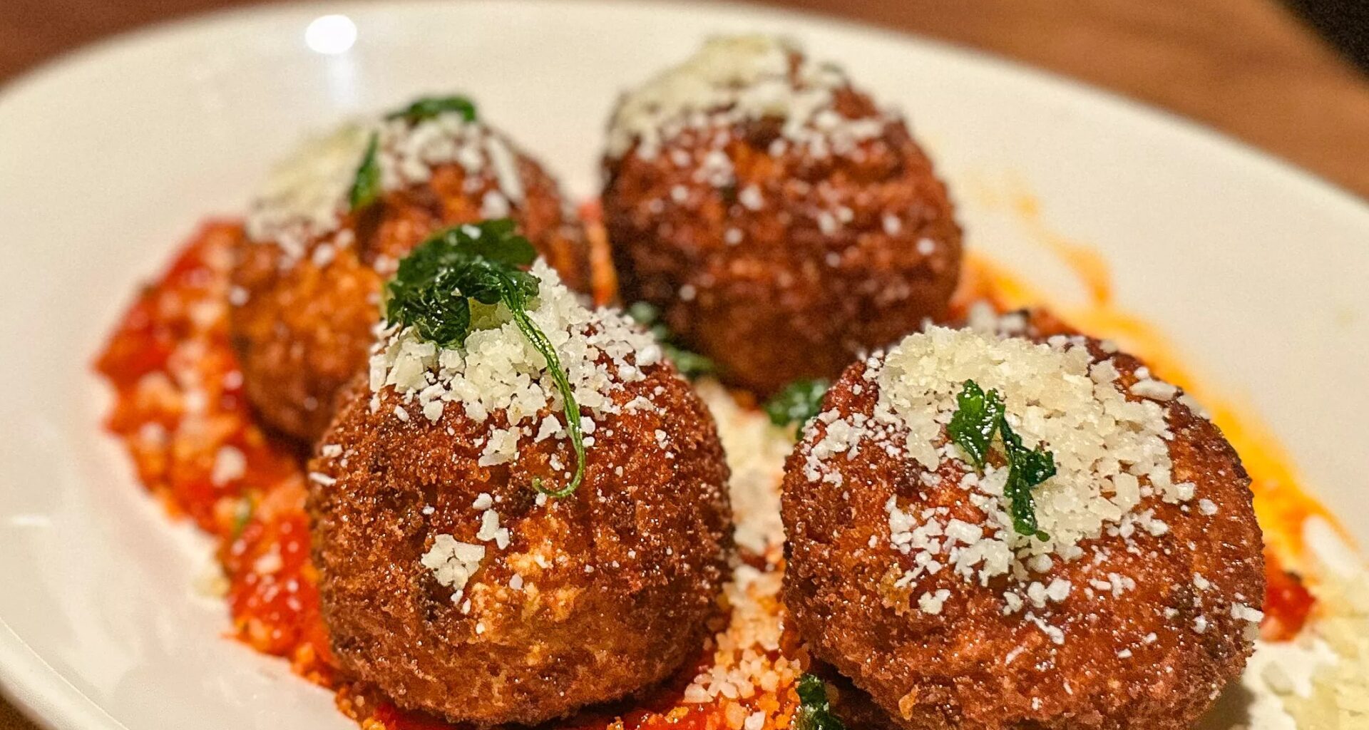 a plate of Cacio e pepe fritters at Seager and Sons