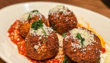 a plate of Cacio e pepe fritters at Seager and Sons