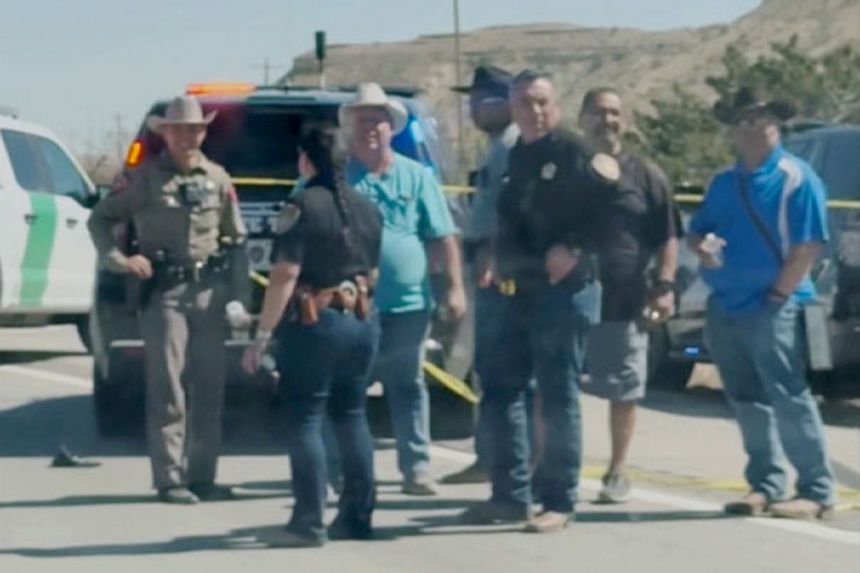 Law enforcement officers surround a crashed vehicle after pursuing the driver in a car chase along Interstate 10 near Van Horn, Texas, on Wednesday.