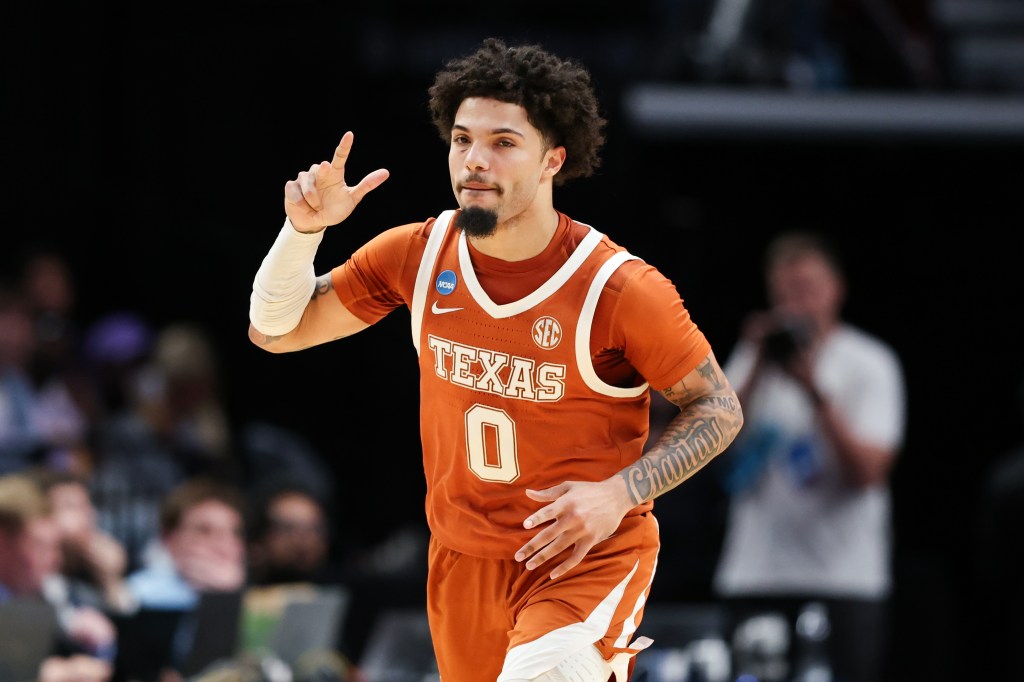 Jordan Pope in a Texas uniform reacts during a basketball game.