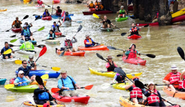 Dozens of kayakers paddle down Buffalo Bayou