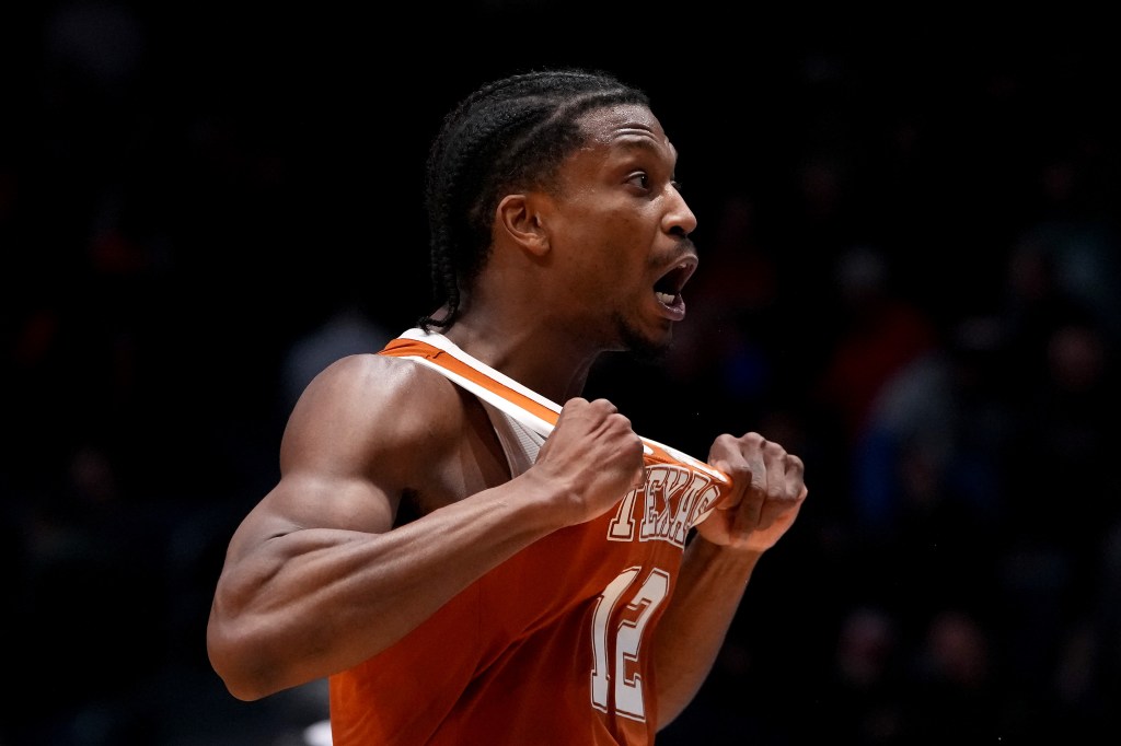 Basketball player Tramon Mark celebrating after making a game-winning shot for the Texas Longhorns.