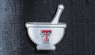 Double T logo on a flat, metal mortar and pestal.