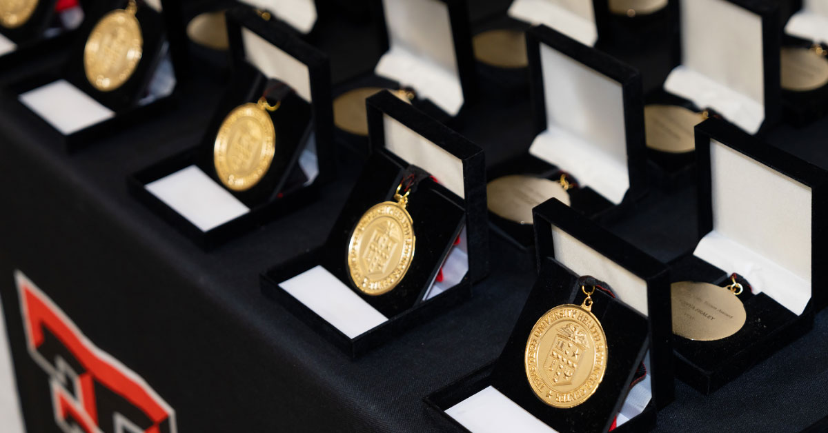 Several award medallions sit on a table.
