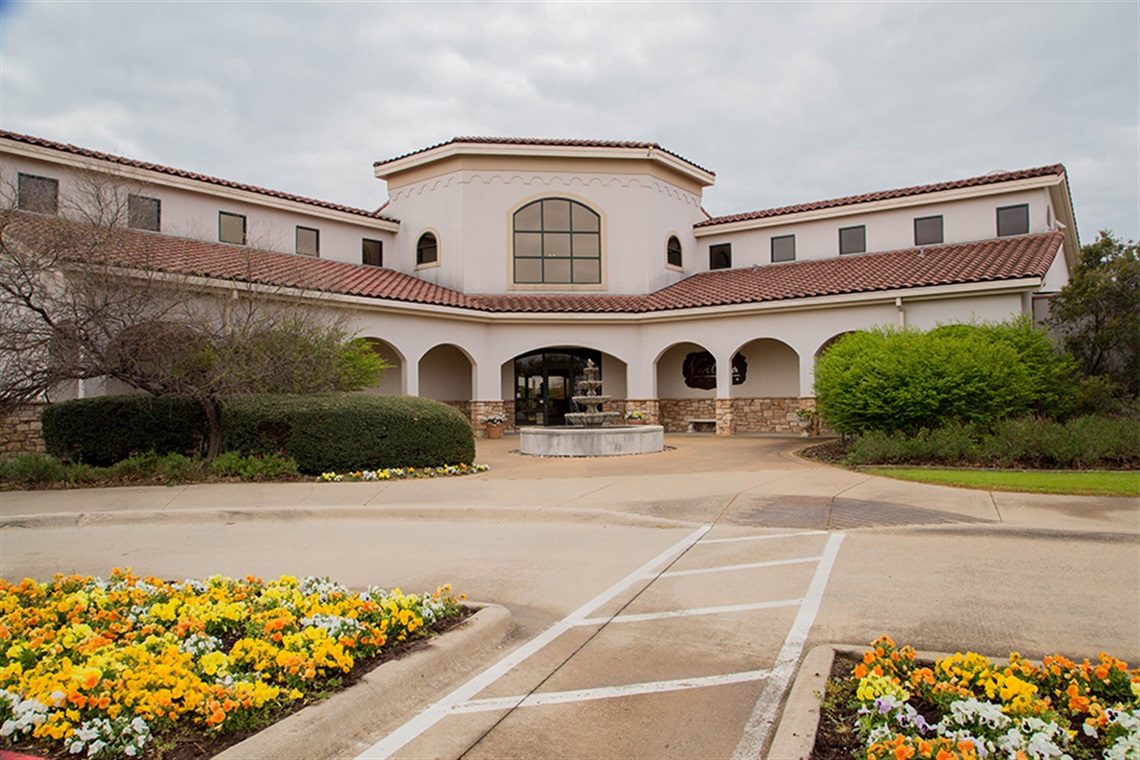 front of Ventana Grille restaurant with yellow flowers in the foreground