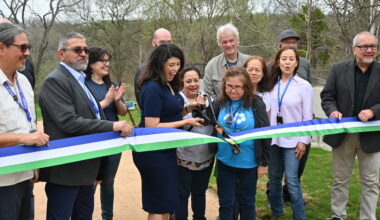 Council Member Fuentes, City of Austin Officials and community members ceremonially cut a ribbon at the greenbelt entrance.