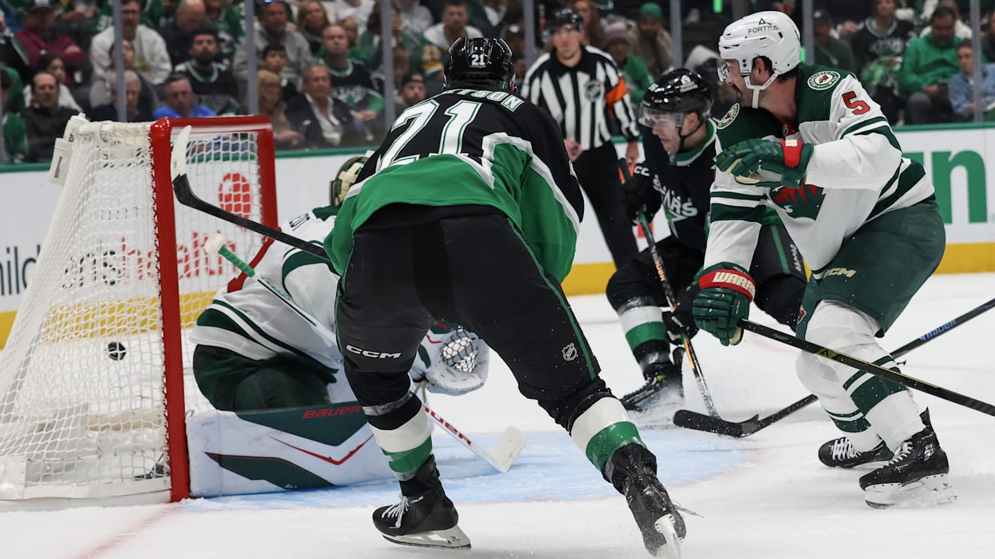 Apr 18, 2026; Dallas, Texas, USA;Dallas Stars left wing Jason Robertson (21) scores on a back hand goal against Minnesota Wild goaltender Jesper Wallstedt (30)  in the second period in game one of the first round of the 2026 Stanley Cup Playoffs at American Airlines Center. Mandatory Credit: Thomas Shea-Imagn Images