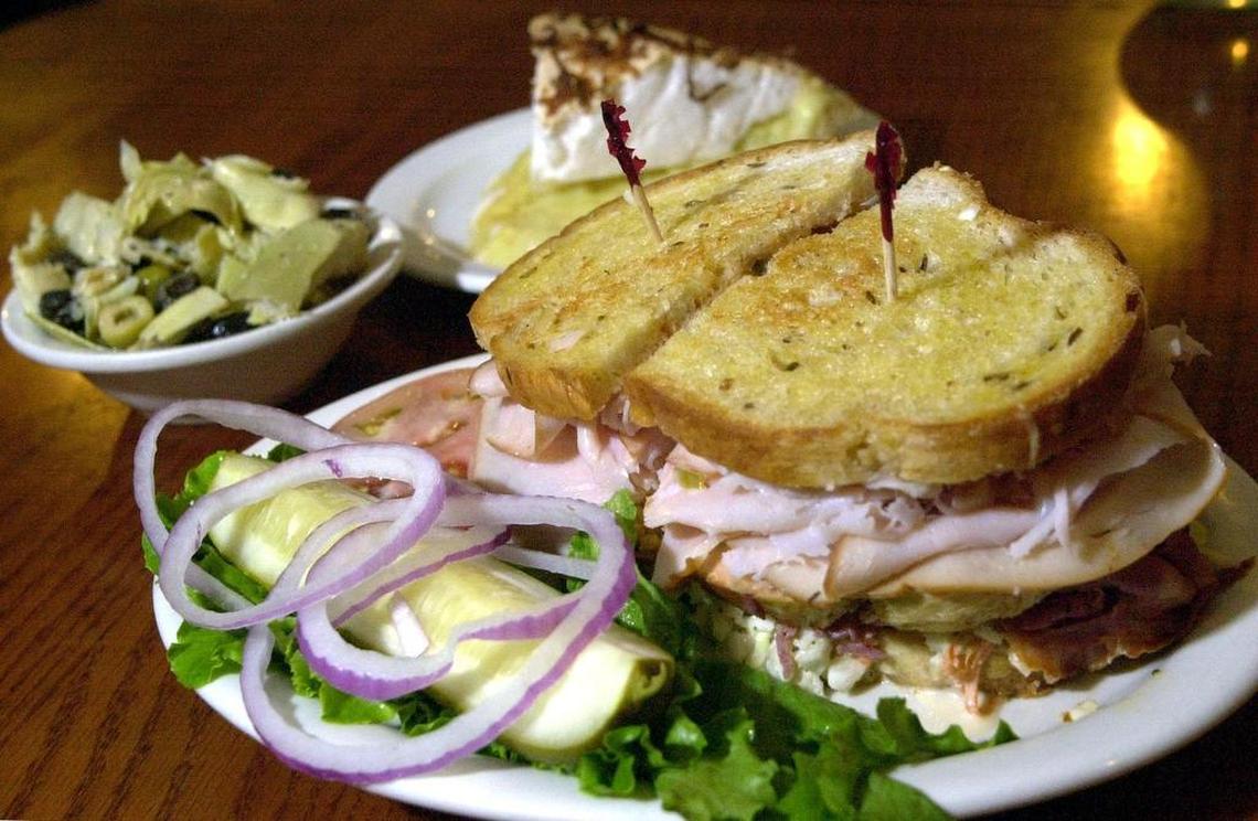 The “Ruthie” sandwich at Carshon’s: three layers of corned beef or roast beef plus turkey and coleslaw with Russian dressing, shown with coconut pie.