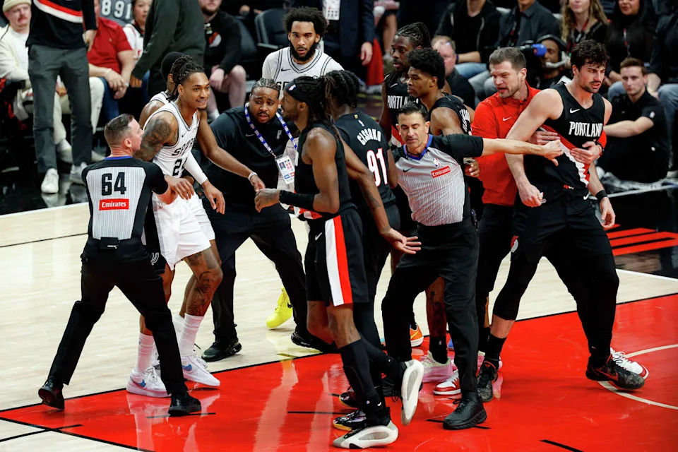 Players and staff swarm the court after a fight broke out between Portland Trail Blazers forward <a class="link " href="https://sports.yahoo.com/nba/players/6401/" data-i13n="sec:content-canvas;subsec:anchor_text;elm:context_link" data-ylk="slk:Deni Avdija;sec:content-canvas;subsec:anchor_text;elm:context_link;itc:0" data-yga="{"yLinkElement":"context_link","yModuleName":"content-canvas","yLinkText":"Deni Avdija","ySubModuleName":"anchor_text","yHasCommerce":false}">Deni Avdija</a> (8) and San Antonio Spurs guard Stephon Castle (5) during the fourth quarter of Game 4 of a first-round NBA playoff series at Moda Center on Sunday, April 26, 2026. Castle and Avdija both received technical fouls. The Spurs won 114-93, leading the series 3-1.Players (Sam Owens/San Antonio Express-News)
