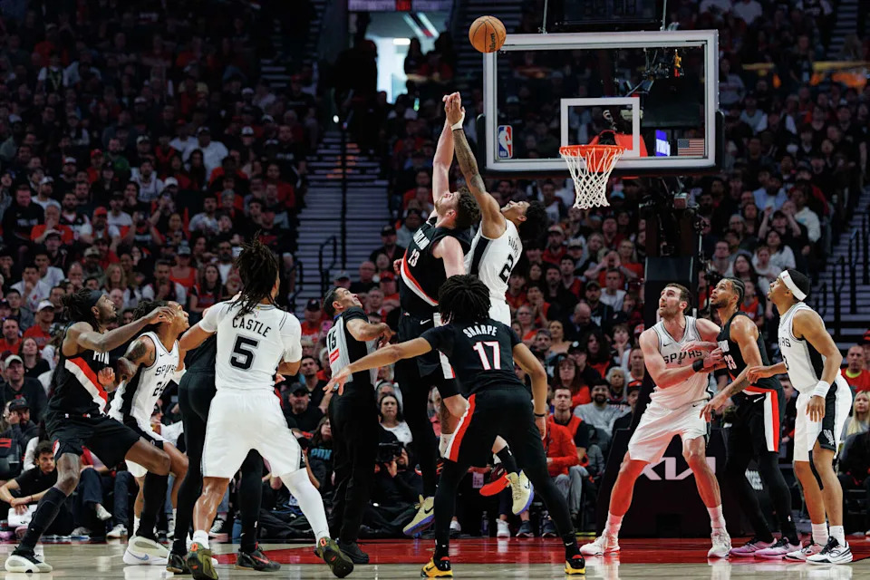 Portland Trail Blazers center Donovan Clingan (23) and San Antonio Spurs guard Dylan Harper (2) fight for a jump ball during the first quarter of Game 4 of a first-round NBA playoff series at Moda Center on Sunday, April 26, 2026. (Sam Owens/San Antonio Express-News)