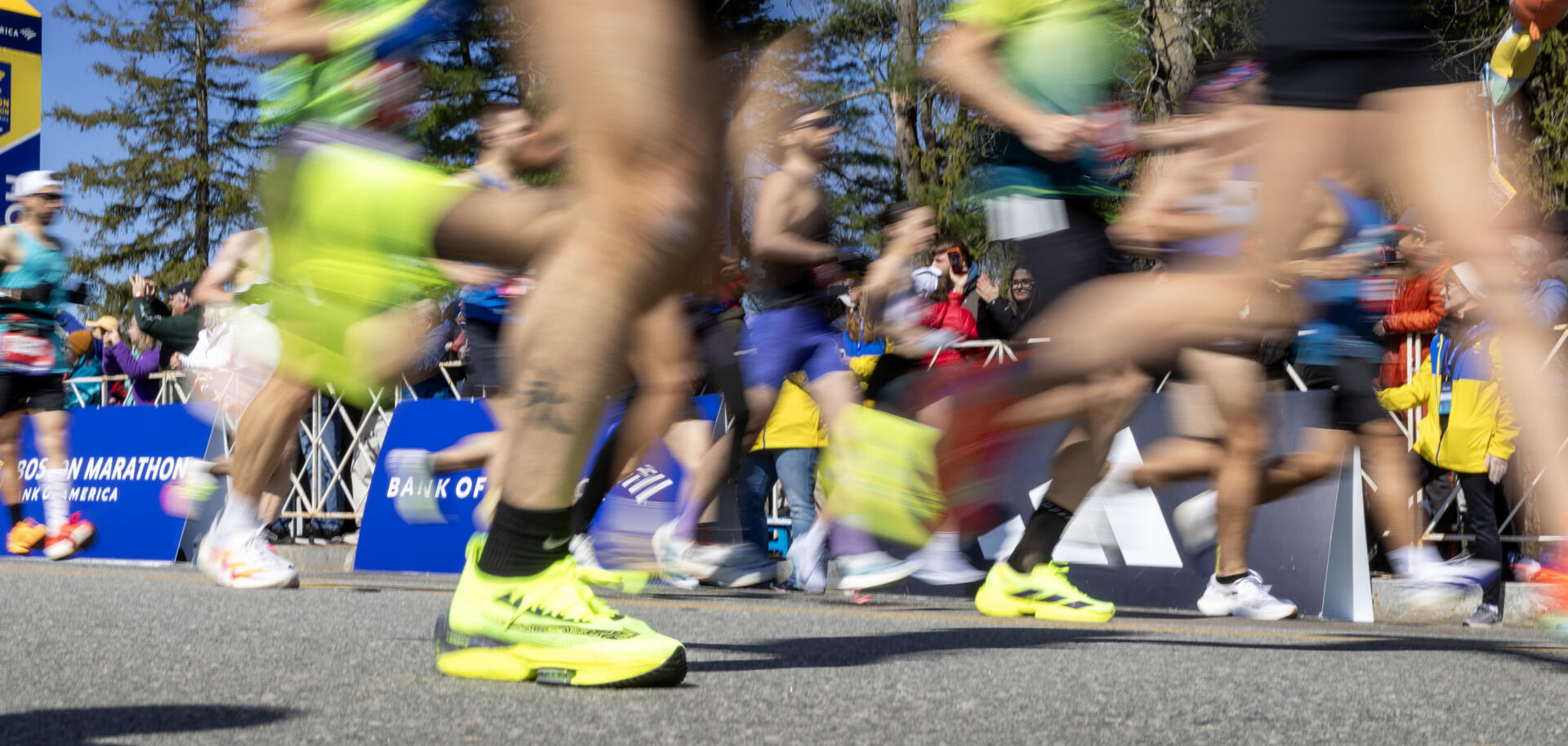 Runners in Wave 1 cross the start line of the Boston Marathon. (Robin Lubbock/WBUR)