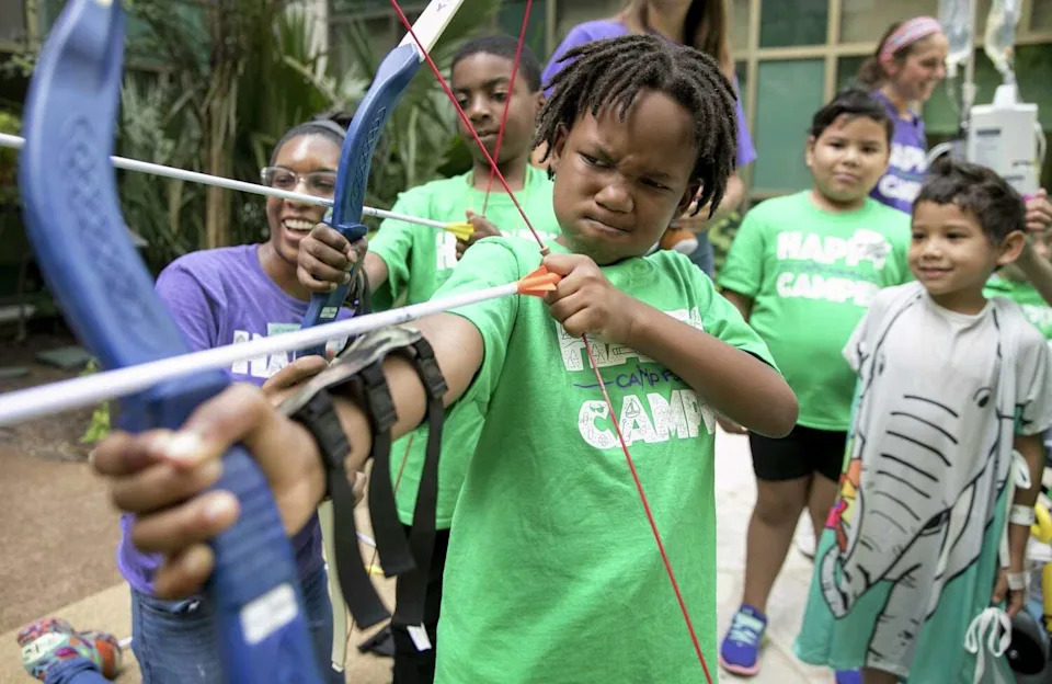 Trent Mbowe, 9, practices archery during the Camp For All 2U at the Dell Children's Medical Center in 2019. Camp For All brings camp activities to kids in hospitals if they can't get to the camp in Burton. (Austin American-Statesman)