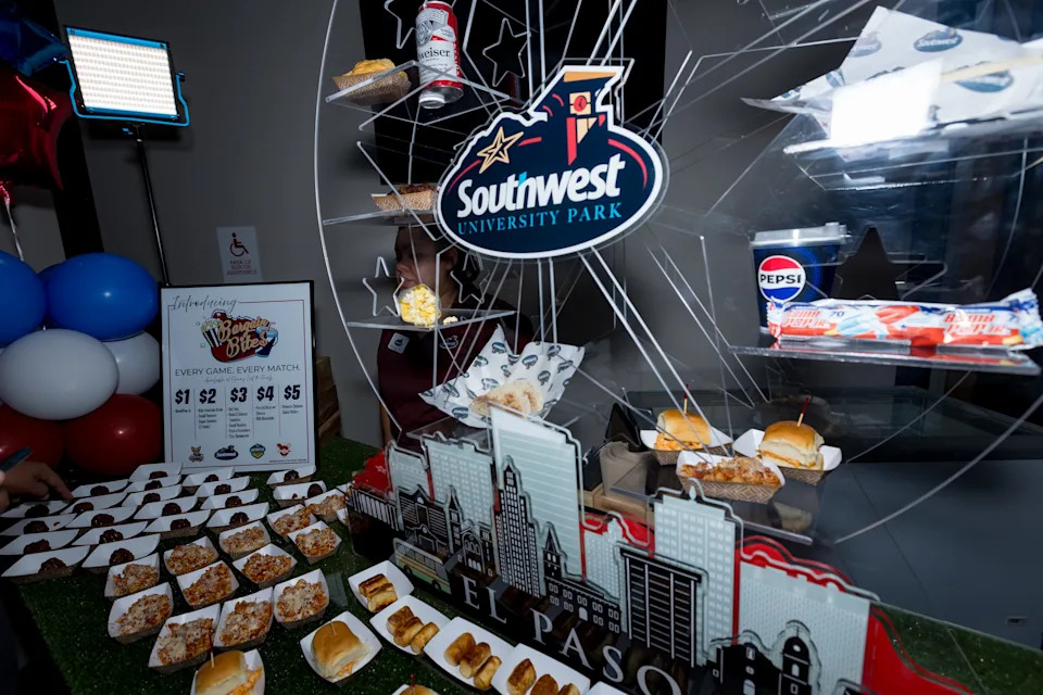 Food samples are displayed beneath a Southwest University Park sign during a food tasting event unveiling Bargain Bites for the El Paso Chihuahuas and El Paso Locomotive FC home games on Wednesday, Feb. 25, 2026, in El Paso, Texas.