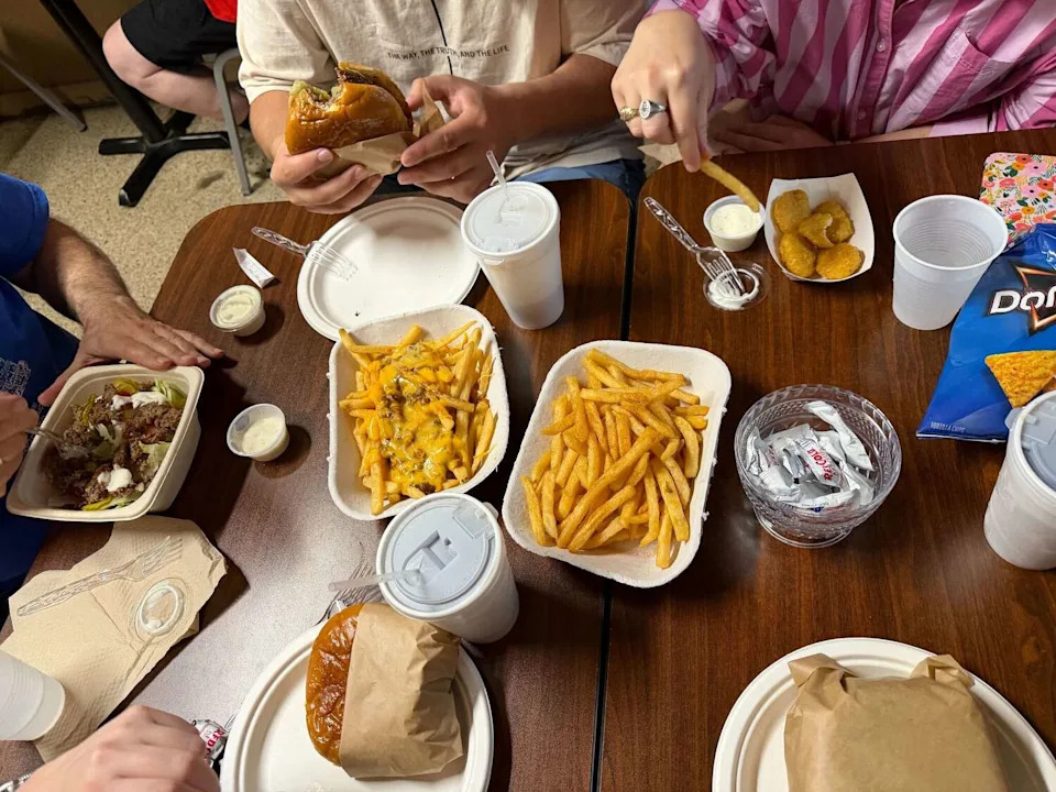 Spread of burgers, fries and chili cheese fries at Top of the Hill Greasy Burgers in Bryan, Texas. (Peter L. Scamardo II/MySA)