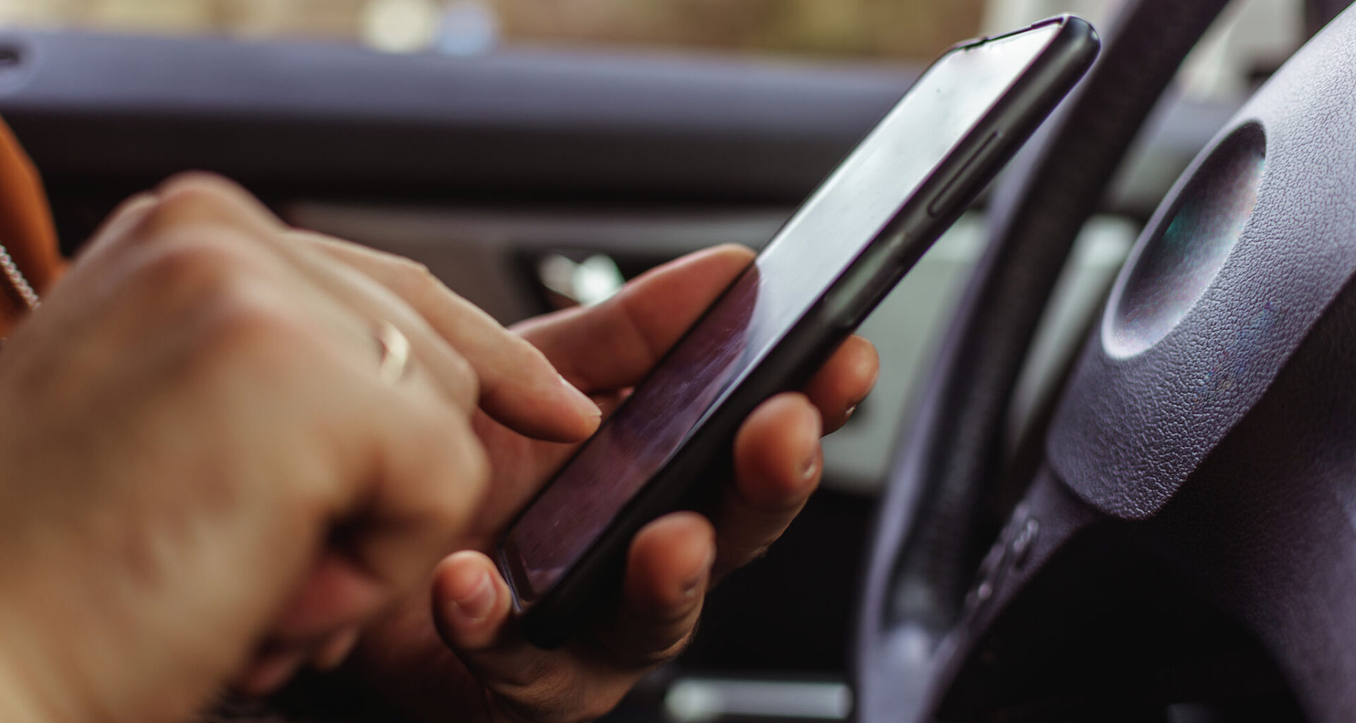 Is it illegal to be on your phone at a red light in Texas?