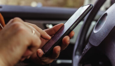 Is it illegal to be on your phone at a red light in Texas?