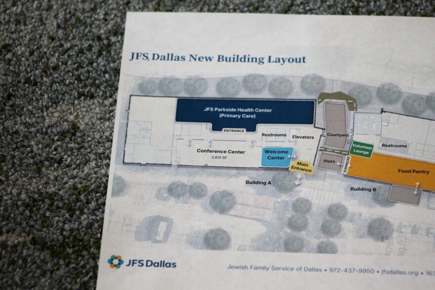 A paper map of JFS Dallas' Addison campus sits on a carpet. The map shows the JFS Parkside Health Center and the lobby.