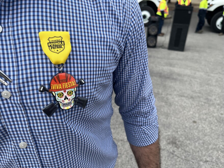 Public Works director Art Reinhardt wears the official Pothole Patrol Fiesta 2026 medal.