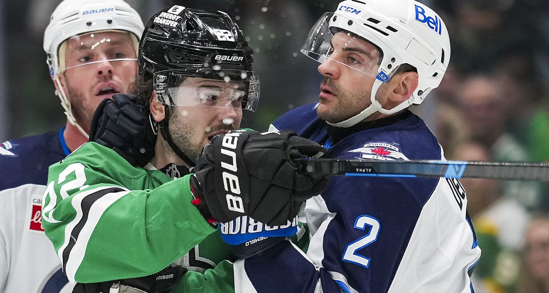 Winnipeg Jets' Adam Lowry (17) and Dallas Stars' Jamie Benn (14) fight in the third period of an NHL hockey game Thursday, April 2, 2026, in Dallas. (AP Photo/Tony Gutierrez)