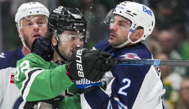Winnipeg Jets' Adam Lowry (17) and Dallas Stars' Jamie Benn (14) fight in the third period of an NHL hockey game Thursday, April 2, 2026, in Dallas. (AP Photo/Tony Gutierrez)
