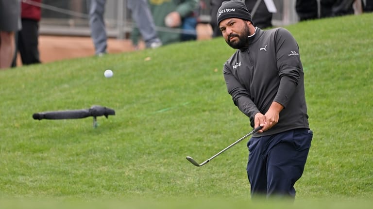 J.J. Spaun pitches onto the 18th green during the fourth...