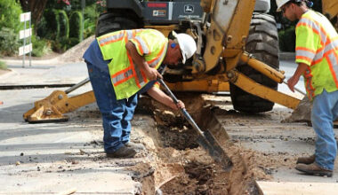 Austin Water workers excavating an underground water pipe.