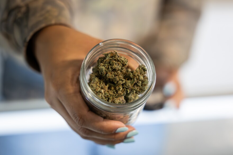 An employee of ATX Organics shows a jar of ATX Organics’ THCA hemp flower on Wednesday, Aug. 27, 2025, at ATX Organics in Austin.