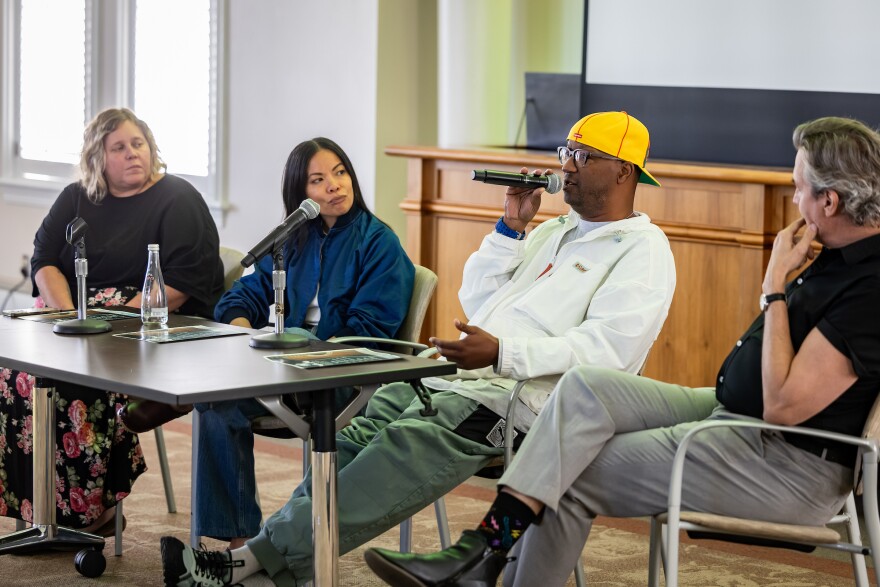 Kristen Townsend, Jamie Dominguez, Terrany “Tee Double” Johnson and Pat Buchta sit behind a desk in front of a classroom during a class on the business of music at St. Edward's University.