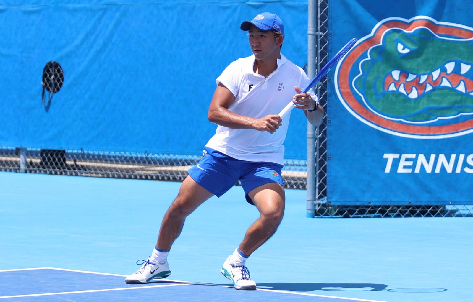 Tanapatt Nirundorn ready to volley at the net in doubles against the LSU Tigers on senior day.
