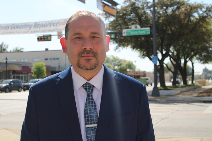 Grand Prairie City Council member John Lopez stands in front of the Grand Prairie Farmers Market, where Dolores Huerta Drive intersects with W Main Street, March 25, 2026.