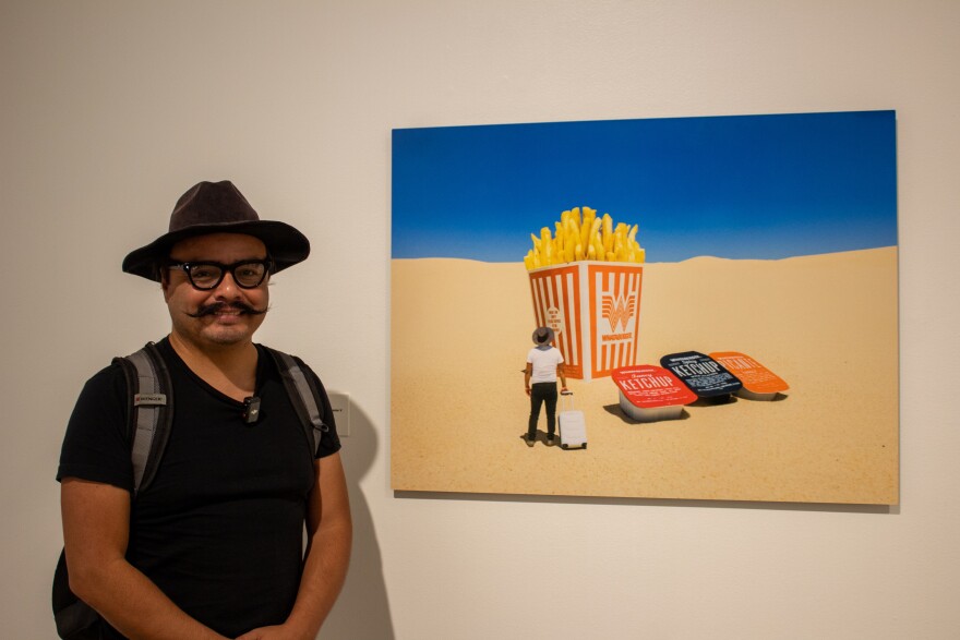 Nain Leon next to one of his Whataburger photographs.