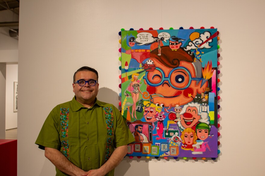 Hector Garza next to his artwork titled “Cuando supiste que eras jochis?"