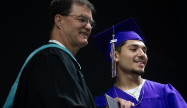 Corpus Christi Independent School District board member Marty Bell, left, poses with a Miller High School graduate during the school's commencement ceremony on May 30, 2025.