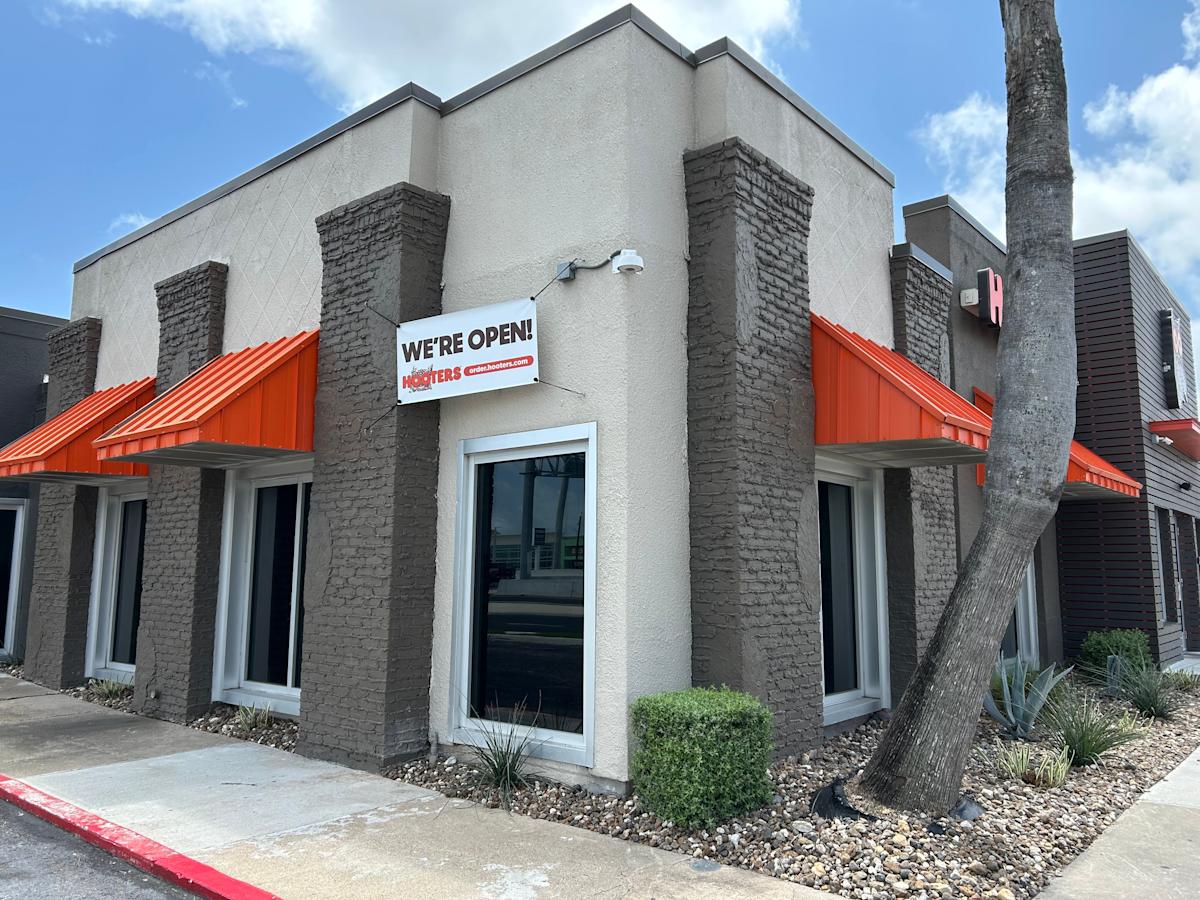 Despite the banner hanging outside the Hooters location in Corpus Christi on April 13, a sign in the door states that the business closed the previous day.