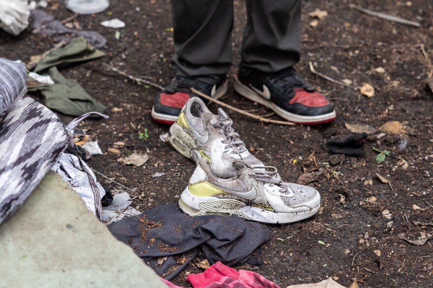 A pair of shoes sits at a former homeless camp outside. 