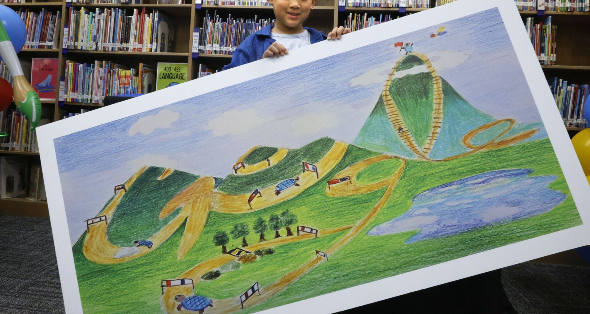 David Bae, a third-grader, poses for a photo with his artwork, which made him one of five finalists in the annual Doodle for Google art contest for kids,  at Skaggs Elementary School, Tuesday, April 14, 2026, in Plano.