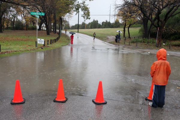 Spectators wait in the rain for the first wave of runners to enter the White Rock Lake area during the 42nd MetroPCS Dallas White Rock Marathon December 4, 2011.
