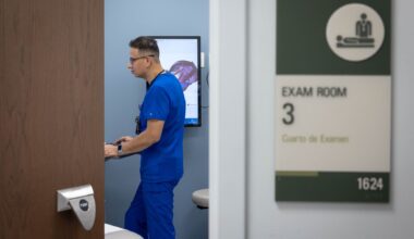 Omar Torres, a licensed vocational nurse, prepares a room for a patient at Parkland's C.V. Roman Health Center in Dallas, Tuesday, April 7, 2026.