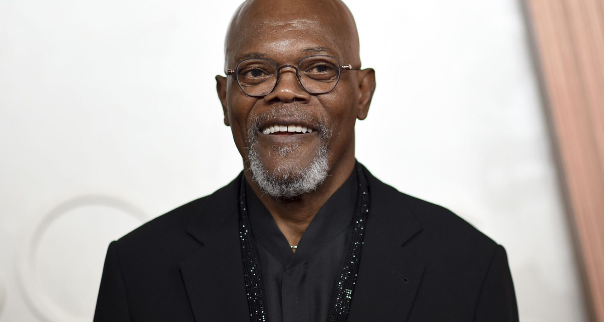People ride the Pandemonium as an American Airlines flight passes by the Six Flags Over Texas swing ride tower on, Saturday, March 9, 2024, in Arlington.