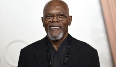 People ride the Pandemonium as an American Airlines flight passes by the Six Flags Over Texas swing ride tower on, Saturday, March 9, 2024, in Arlington.