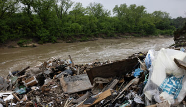 Trash, including building materials, washes into the Trinity River from the illegal dump along the McCommas Bluff.