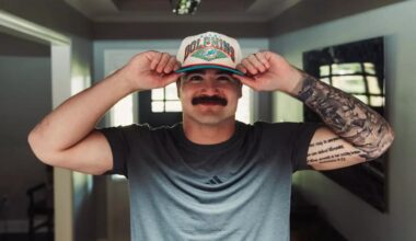 Caleb Douglas donning Miami Dolphins hat with Texas Tech coach Juice Johnson