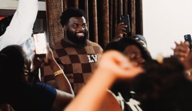 Caleb Douglas donning Miami Dolphins hat with Texas Tech coach Juice Johnson
